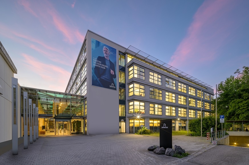 Beleuchtetes Rodenstock-Gebäude in München in der Dämmerung